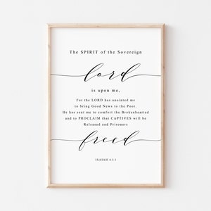 May include: A black and white printable wall art print with a quote from the Bible, Isaiah 61:1. The quote reads "The Spirit of the Sovereign Lord is upon me, For the Lord has anointed me to bring Good News to the Poor. He has sent me to comfort the Brokenhearted and to proclaim that Captives will be Released and Prisoners Freed."