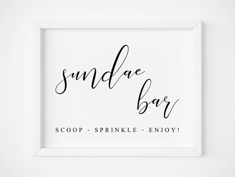 May include: White framed sign with black calligraphy that reads "sundae bar" and the text "SCOOP - SPRINKLE - ENJOY!"
