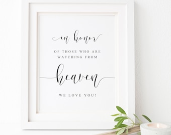 May include: A white framed sign with black calligraphy that reads "in honor of those who are watching from heaven we love you!"
