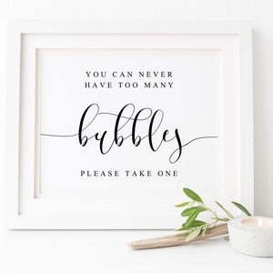 May include: White framed sign with black text that reads "You can never have too many bubbles. Please take one."