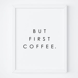 May include: A white framed print with black text that reads "BUT FIRST COFFEE."