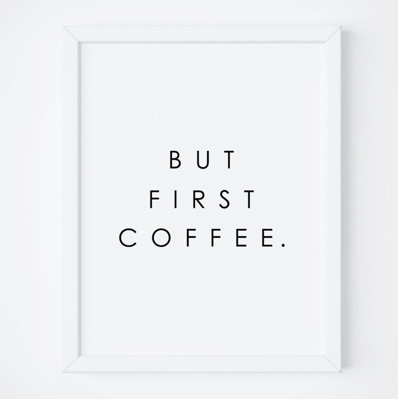 May include: A white framed print with black text that reads "BUT FIRST COFFEE."