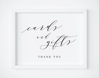May include: White frame with a black and white sign that says "cards and gifts" with the words "thank you" below.
