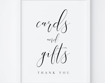 May include: White framed sign with black calligraphy text that reads "cards and gifts thank you".