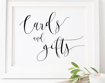 May include: White framed sign with black calligraphy that reads "Cards and gifts".
