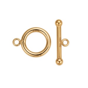May include: Gold-toned metal toggle clasp with a round ring and a straight bar. The bar has a small round knob on each end and the text "14K" is engraved on the side.