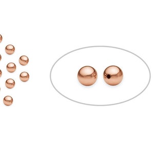 May include: A group of 20 rose gold beads, with two beads highlighted in a separate image. The beads are round and have a smooth, shiny finish.