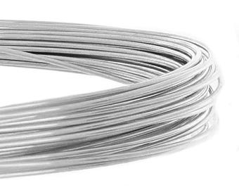 May include: A coil of silver-colored wire, tightly wound and displayed against a white background. The wire appears smooth and reflective, suggesting a metallic composition. The image highlights the texture and form of the coiled wire, suitable for crafting or jewelry making.