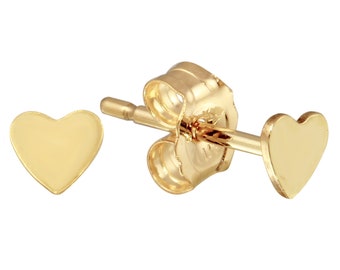 May include: A pair of gold heart-shaped stud earrings. The earrings are small and delicate, and they would make a great gift for someone special.