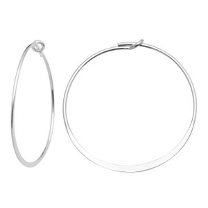 May include: A pair of silver hoop earrings. The hoops are thin and flat, and they have a simple, elegant design.