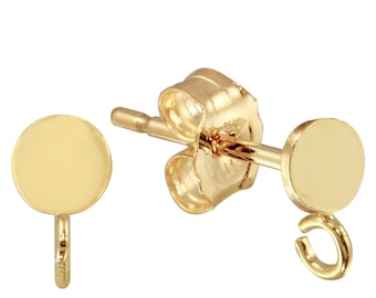 May include: A pair of gold-toned stud earrings with a round disc and a small loop on the back. The earrings are designed to be used with a charm.