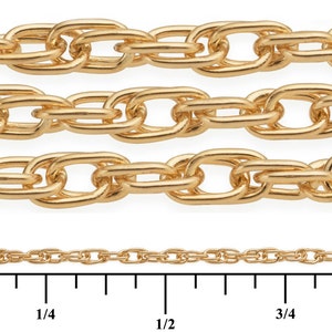 May include: Four rows of gold chain, each with a different size and link style. The chains are laid out on a white surface with a ruler underneath. The ruler is marked in inches, with markings at 1/4, 1/2, 3/4, and 1 inch.