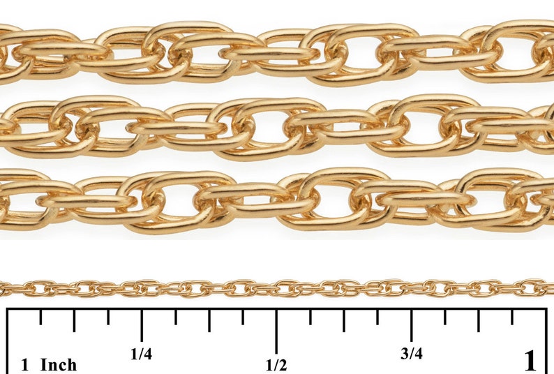 May include: Four rows of gold chain, each with a different size and link style. The chains are laid out on a white surface with a ruler underneath. The ruler is marked in inches, with markings at 1/4, 1/2, 3/4, and 1 inch.