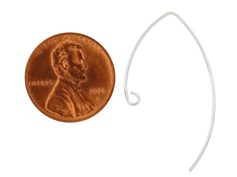 May include: A silver earring hook, shown next to a US penny for size comparison. The hook is a simple, curved shape with a small loop at the top.