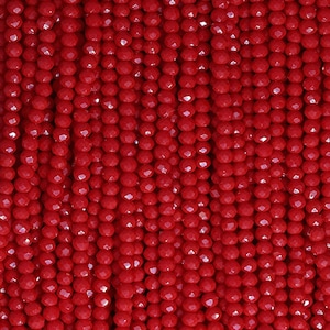 May include: Close-up of strands of faceted red beads. The beads are small, round, and have a glossy finish. The beads are strung together, creating a dense, textured surface. The color is a vibrant, deep red.
