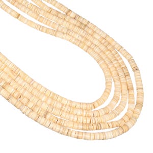May include: A multi-strand necklace composed of five individual strings of small, flat, circular, off-white disc beads. The beads have a smooth, matte texture and are arranged in a cascading, curved formation, creating a layered appearance.