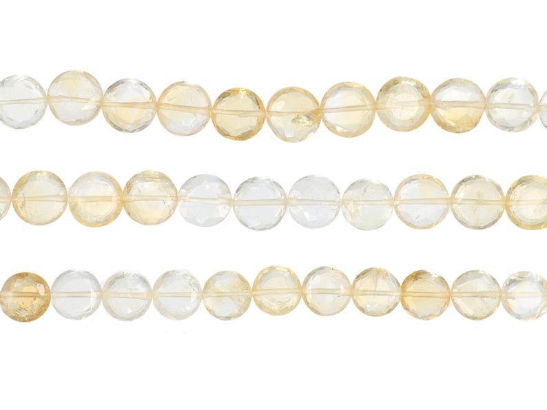 May include: Three strands of faceted citrine gemstone beads. The beads are round, with a mix of clear and pale yellow hues. The beads are strung together, creating a natural and elegant look. Ideal for jewelry making.