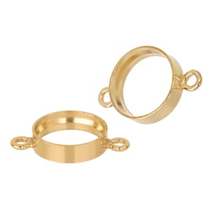 May include: Two gold-toned metal bezel settings with two loops on each side. The bezels are round and have a smooth finish.