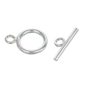 May include: A silver-colored toggle clasp, featuring a circular ring with a loop and a straight bar with a loop. This jewelry finding is designed for secure closure of necklaces and bracelets.