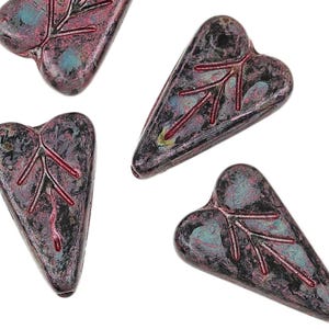 May include: Four dark gray heart-shaped glass beads with red leaf designs. The beads have a mottled, textured surface.