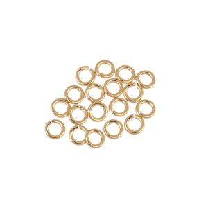 May include: A group of 20 gold jump rings, a type of jewelry finding, are scattered on a white background.