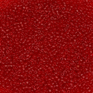 May include: A close-up image of a large quantity of small, red, round seed beads. The beads are arranged in a random pattern, creating a textured surface.