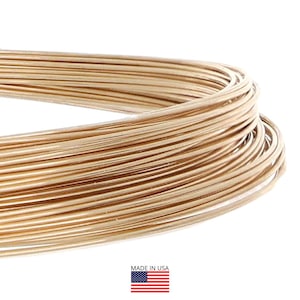 May include: Close-up of a coil of gold-colored wire. The wire is tightly wound, with multiple strands visible. The image is set against a white background. The words "MADE IN USA" are printed below the wire, along with the American flag.