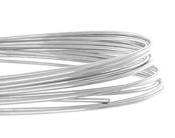 May include: Close-up of a coil of silver-colored wire. The wire is tightly wound, with multiple strands visible. The wire has a smooth, metallic finish and is set against a white background.