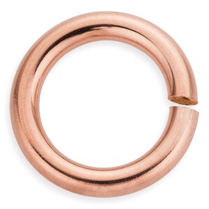 Puede incluir: Un anillo de salto de oro rosa, un anillo de metal con un espacio, utilizado para la fabricaci&oacute;n de joyas.