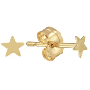 May include: A pair of gold star stud earrings. The earrings are small and delicate, and they would make a great gift for a friend or loved one.
