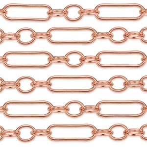 May include: A close-up of a rose gold chain with oval and round links. The chain is made of metal and has a shiny finish.