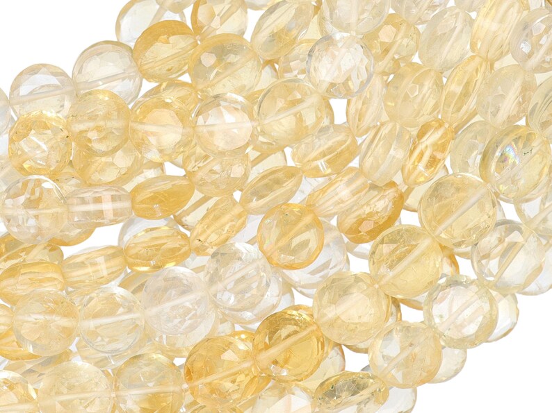 May include: A collection of faceted citrine gemstone beads in various shapes and sizes. The beads range in color from pale yellow to a deeper golden hue, with a translucent quality.