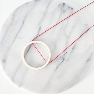 white minimalist circle pendant on bright orange silk / 12th, 18th, 20th anniversary gift / ceramic handmade jewelry / gift for her image 4