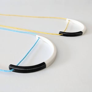 Geometric black and white porcelain necklace on turquoise or yellow cord