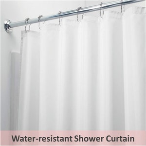 May include: A white, water-resistant shower curtain suspended from a chrome rail with metal hooks. The curtain is made of a smooth, opaque material and is partially closed. Text at the bottom reads "Water-resistant Shower Curtain."