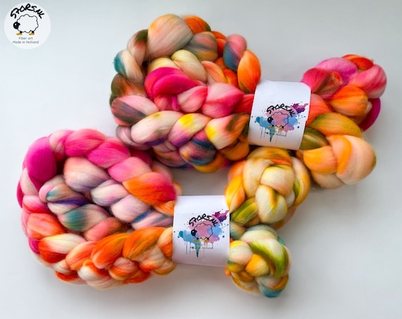 Hand dyed superwash extra fine Merino top. ‘Technicolor rainbow’. Hand dyed roving with fluoriscent accents.