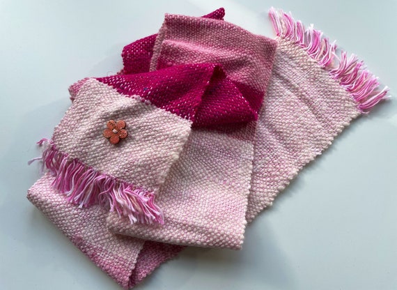 Small hand spun and hand woven scarf in pinks and white. With alpaca, merino wool and sari silk on a cotton warp.