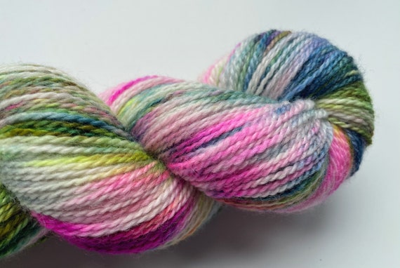 Hand dyed Polwarth and Tussah silk sock yarn. Fluorescent speckles.