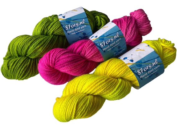 Hand dyed superwash Merino Aran weight yarn. Semi solid fluoriscent green, yellow or pink.