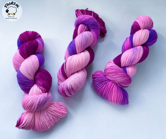 Hand dyed superwash Merino and bio nylon light fingering weight yarn. ‘Electric berries’