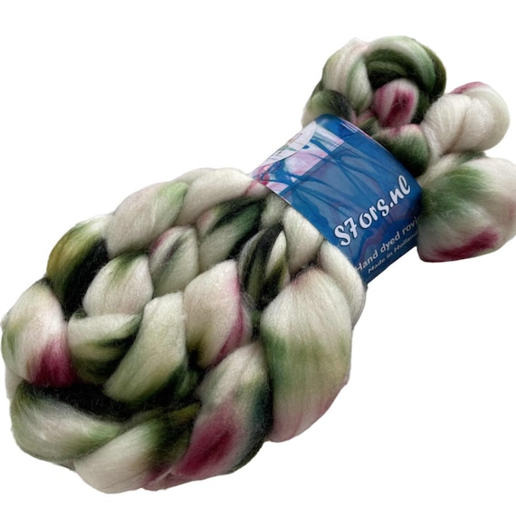 Hand dyed superwash extra fine Merino top. ‘Magnolia tree’. Soft roving with green and pink stripes on a white base.