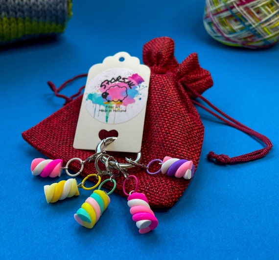 Five stitch markers with marshmallow  decorations.