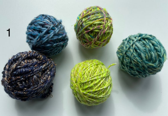 Mini skeins hand spun art yarn. Five assorted 20 grams balled skeins in a gift bag. Ideal for weaving.