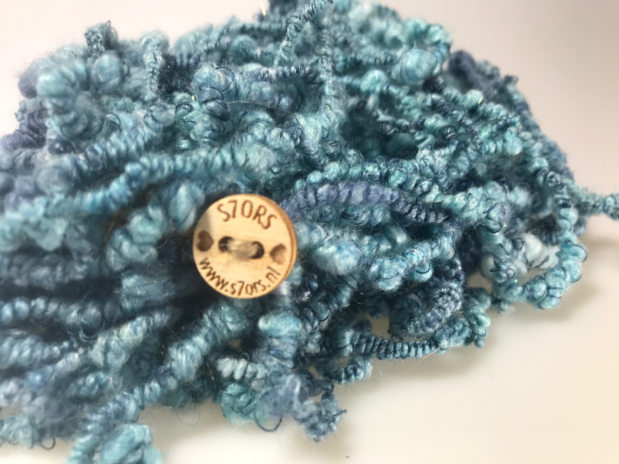 Hand spun art yarn with beads. Supercoils in blue with glitter, thread