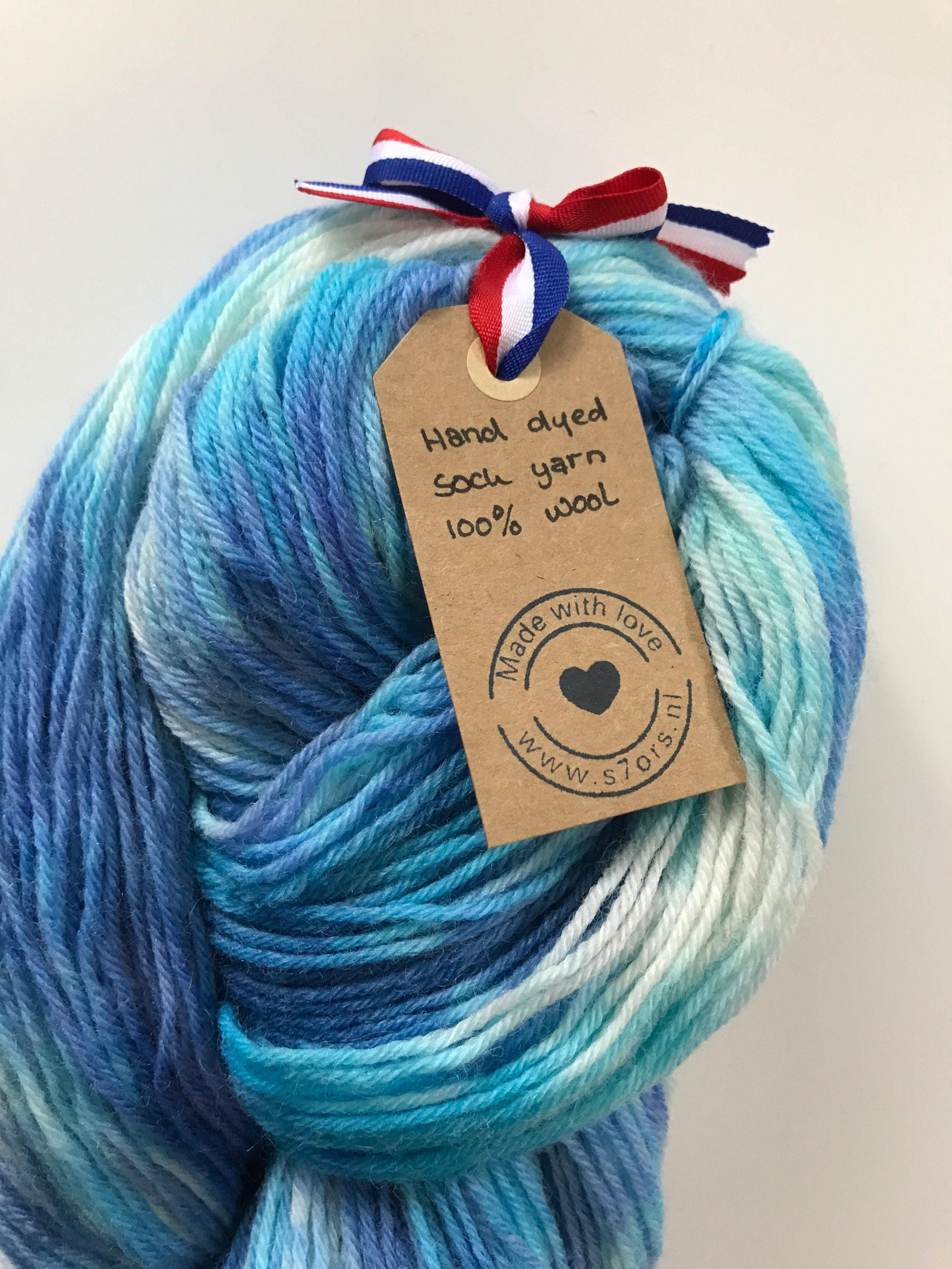 Hand dyed fine wool yarn in shades of blue and white.