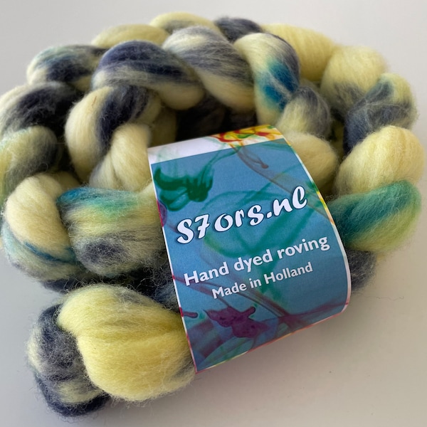 Hand dyed German Merino top 25 micron. Ideal for spinning or felting. Soft yellow with blue speckles.