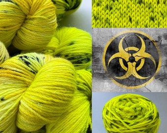 Hand dyed superwash DK weight yarn. Fluoriscent yellow with steel blue speckles ‘Biohazard’.