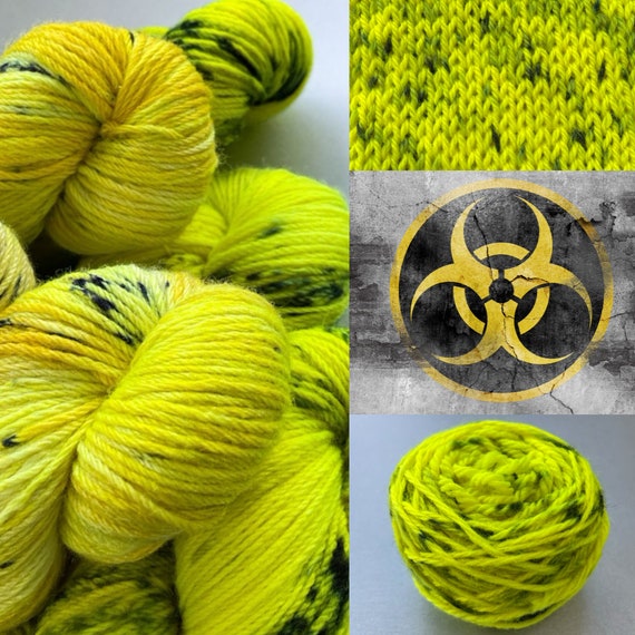 Hand dyed superwash DK weight yarn. Fluoriscent yellow with steel blue speckles ‘Biohazard’.