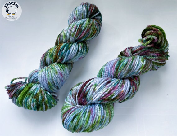 Hand dyed superwash Merino Aran weight yarn.  ‘Laying under the cherry tree’.