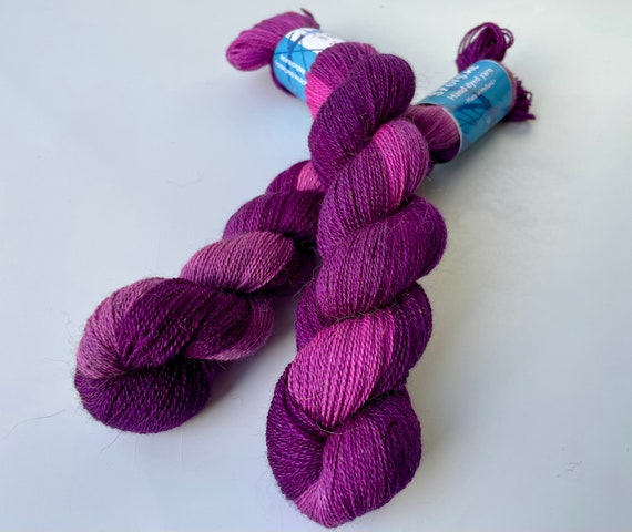Hand dyed superwash superfine Merino, Alpaca and mulberry silk yarn. Pooling pink and deep purple.